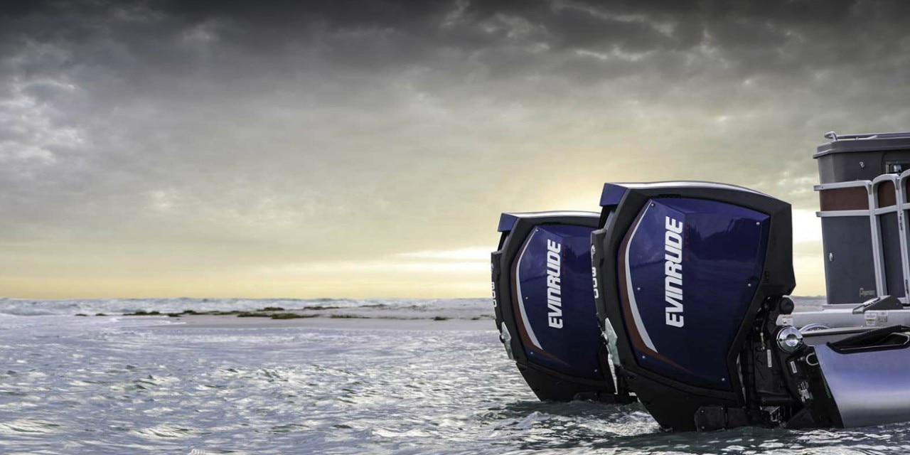 Two Evinrude outboard motors on a pontoon boat Two Evinrude outboard motors on a pontoon boat