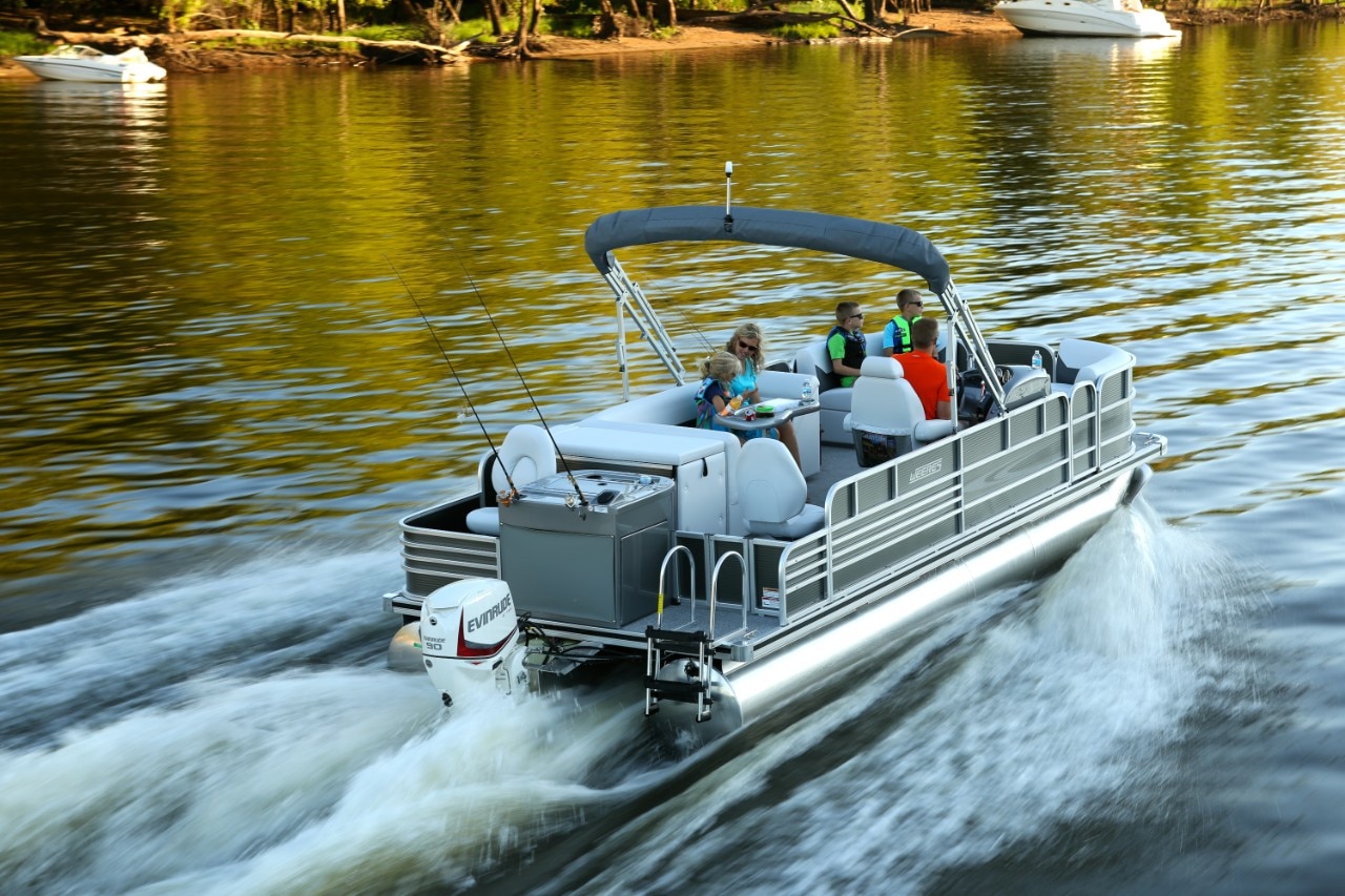 Pontoon boat going at high speed on a body of water Pontoon boat going at high speed on a body of water